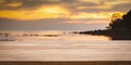 Empty wooden bar counter with blurred sunset beach background Royalty Free Stock Photo