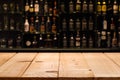 Empty wooden bar counter with defocused background and bottles of restaurant Royalty Free Stock Photo