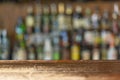 Empty wooden bar counter with defocused background and bottles of restaurant, bar or cafeteria background Royalty Free Stock Photo