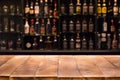 Empty wooden bar counter with defocused background and bottles of restaurant Royalty Free Stock Photo