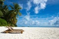 Empty wooden beach chairs on the tropical beach, vacation. Traveler dreams concept Royalty Free Stock Photo