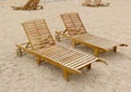 Empty wooden beach sun lounges on a sandy lake bank Royalty Free Stock Photo