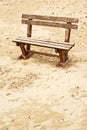 Empty wooden bench on the beach in cloudy weather Royalty Free Stock Photo