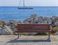 Empty wooden bench at boat dock with beautiful blue sea and dock Royalty Free Stock Photo