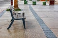 Empty wooden bench on sidewalk of promenade Royalty Free Stock Photo