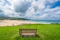 Empty wooden bench in above Porthemor beach