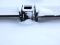 Empty wooden bench under snow after heavy snowfall Royalty Free Stock Photo