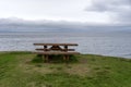 Empty wooden bench with view over fjord