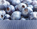 Empty wooden,blue table with fresh blueberries in background, ready for your product display montage. Royalty Free Stock Photo