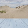 Empty wooden,blue table ready for your product display montage with dunes of sand in background, UK Royalty Free Stock Photo