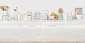 Empty wooden board with copyspace on defocused kitchen counter background