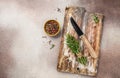 Empty wooden board with herbs and spices on black kitchen table. culinary background, top view Royalty Free Stock Photo