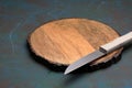 An empty wooden board with a knife on a bluish wooden background with copy space