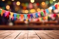 Empty wooden board for product displaying with festive decorative flags, colorful buntings and wood backdrop, festival background