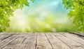 Empty of wooden board table top with green leaves and bokeh background, Mock up for display product Royalty Free Stock Photo