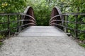 Empty wooden boardwalk bridge trail path through the wooded forest park on summer day Royalty Free Stock Photo