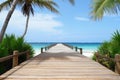 an empty wooden boardwalk leading to a tropical beach