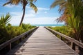 an empty wooden boardwalk leading to a tropical beach