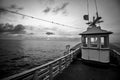 Empty wooden boat sailing offshore at dawn