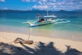 Empty wooden boat and white beach on sunny day. Tropical island paradise photo. Philippine island hopping tour Royalty Free Stock Photo