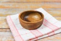 Empty wooden bowl on tablecloth napery on dining table / natural kitchen products