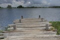 Empty wooden bridge over pond with lightning background Royalty Free Stock Photo