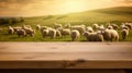 The empty wooden brown table top with blur background of sheep pasture. Exuberant.