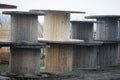 Empty wooden cable reels outdoors during a cold rainy day