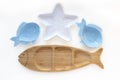 Empty wooden and ceramic plates in shape of fish and starfish isolated on white background. Flat lay, top view Royalty Free Stock Photo