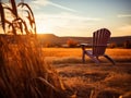 Empty wooden chair in a golden field with a sunset and mountains in the background. Concept of peaceful solitude