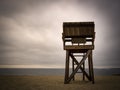 Lifeguard stand on the beach against overcasting cloudy sky.