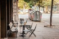 Empty wooden chairs and tables in a street used as a terrace of a cafe bar restaurant, with nobody to seat and drink, in summer Royalty Free Stock Photo