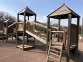 Empty wooden children playground with slide in spring park Royalty Free Stock Photo