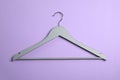 Empty wooden clothes hanger on color background Royalty Free Stock Photo