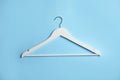 Empty wooden clothes hanger on color background Royalty Free Stock Photo