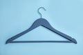Empty wooden clothes hanger on color background Royalty Free Stock Photo