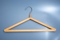 Empty wooden clothes hanger with metal hook Royalty Free Stock Photo