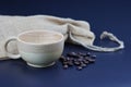 Empty wooden coffee cup with coffee bean and bag on black color background. Royalty Free Stock Photo