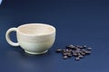 Empty wooden coffee cup with coffee bean on black color background. Royalty Free Stock Photo