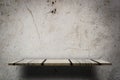 Empty wooden counter display on grungy cement wall Royalty Free Stock Photo