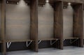 Empty wooden cubicles with bench and hangers