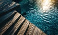 Empty wooden deck swimming pool steps with clear water surface background Royalty Free Stock Photo