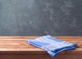 Empty wooden deck table with blue cheched tablecloth over blackboard background for product montage Royalty Free Stock Photo