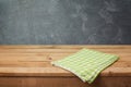 Empty wooden deck table with checked tablecloth over blackboard background Royalty Free Stock Photo