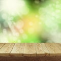 Empty wooden deck table with foliage bokeh background for product display montage. Spring or summer Royalty Free Stock Photo