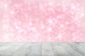 Empty wooden deck table over abstract blurred light pink christmas background texture with stars. Template for your product Royalty Free Stock Photo