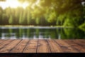 Empty wooden deck table over blurred lake forest with sunlight background, product display montage Royalty Free Stock Photo