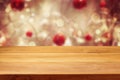 Empty wooden deck table over Christmas bokeh background Royalty Free Stock Photo