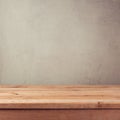 Empty wooden deck table over grey grunge wallpaper