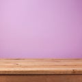 Empty wooden deck table over purple violet wallpaper. Easter spring background Royalty Free Stock Photo